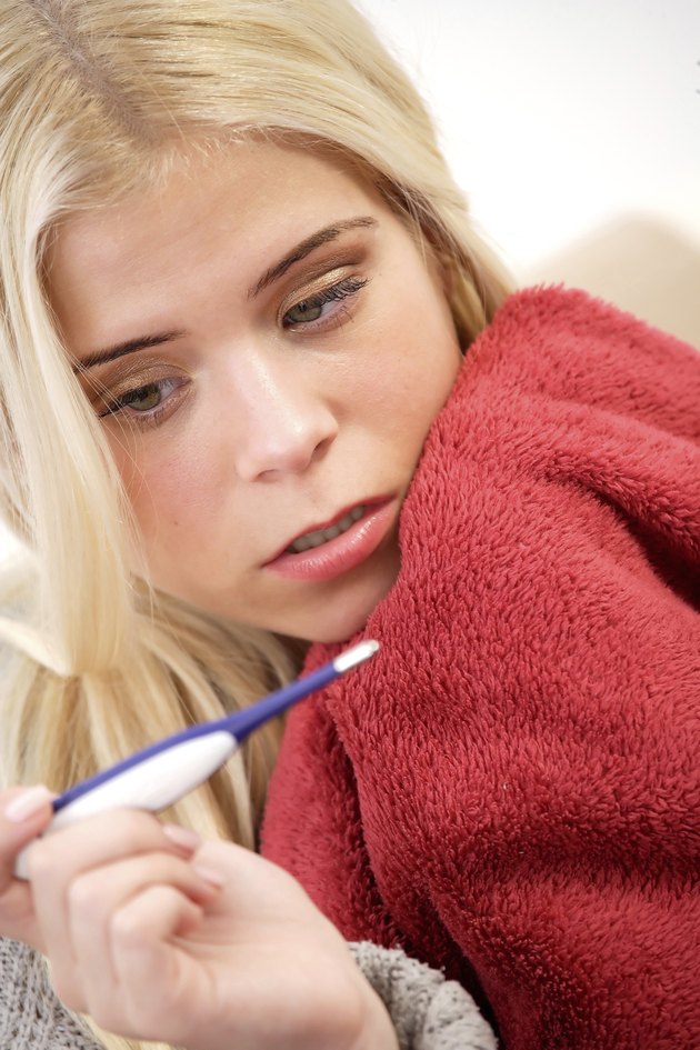 Woman looking at a thermometer