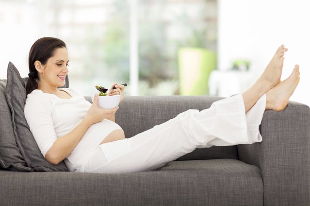 healthy pregnant woman eating vegetable salad
