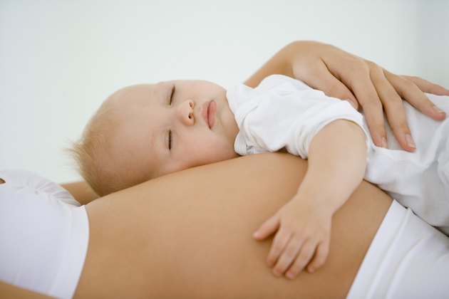 Baby sleeping on pregnant woman's stomach