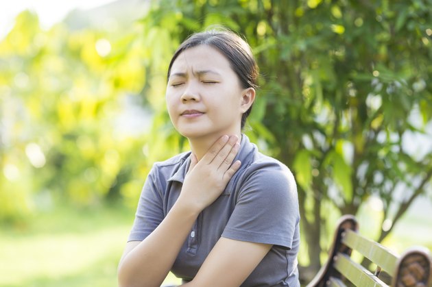 Woman has Sore Throat at Park