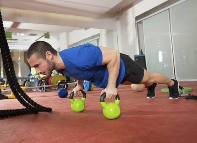 Crossfit fitness man push ups Kettlebells pushup exercise