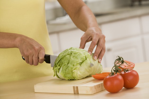 Woman cutting lettuce