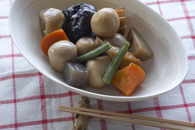 Bowl of Japanese vegetables with chopsticks, close-up