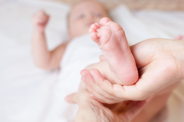 Mother makes healthy massage for baby