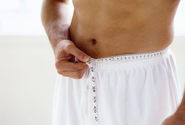 close-up of an inch tape wound around a man's waist