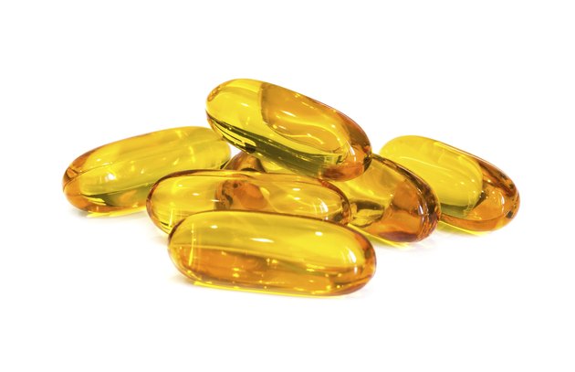 Fish oil supplement capsules isolated on white background