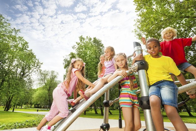 Kids on playground construction play, girl climb