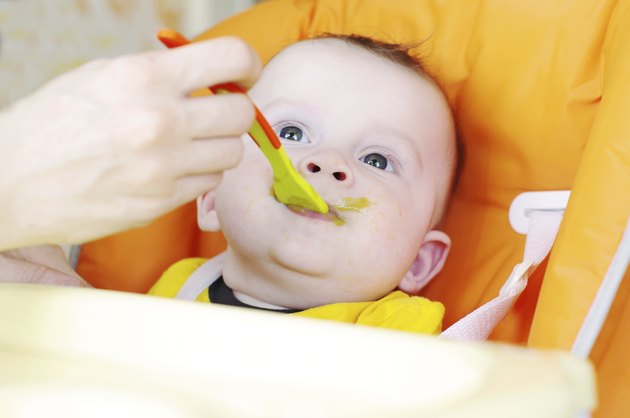baby is fed by puree
