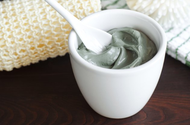 Grey cosmetic clay in a bowl