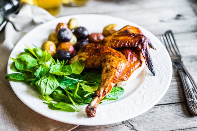 Roasted half chicken with potatoes and spinach