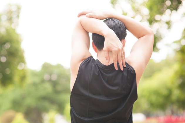 Athletic stretching in the morning and watching nice nature view