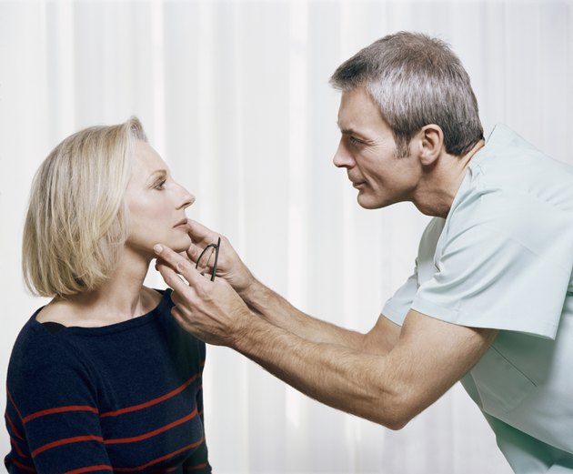 Cosmetic Surgeon Examining a Patients Face
