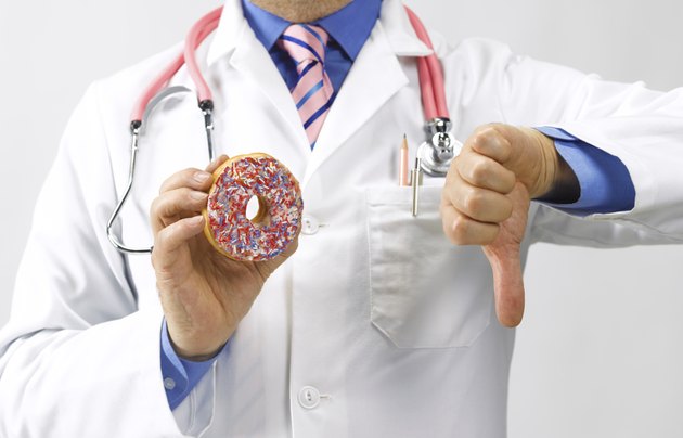 A doctor gives thumbs down to a doughnut