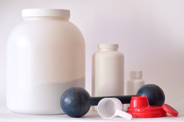 Big jar of protein powder, bottles and shaker