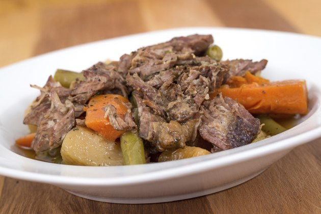 braised beef pot roast stew with vegetables on table