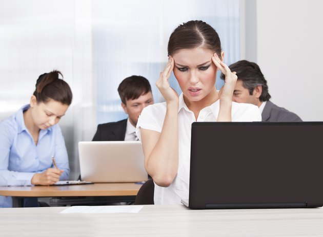 Young Businesswoman Suffering From Headache