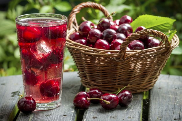 Freshly harvested sweet cherries and juice from them with ice