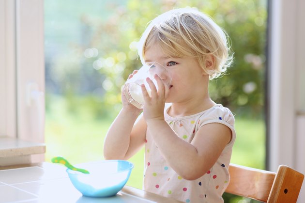 Little girl having breakfast indoors