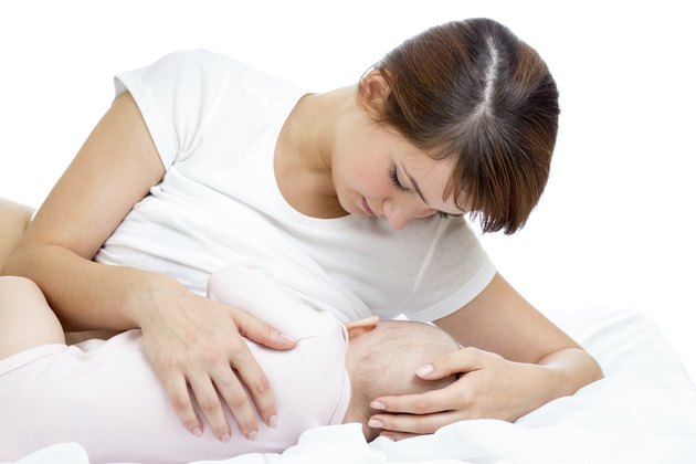 happy mother breast feeding her baby infant