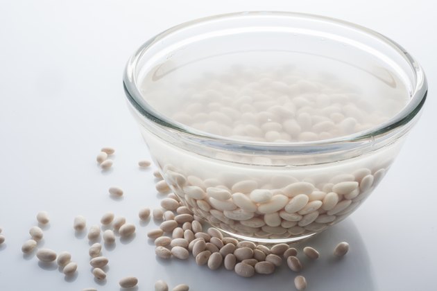 Soaked and scattered beans on white