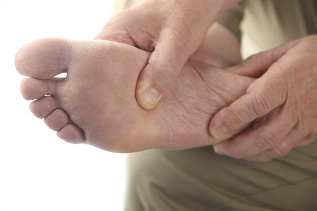 man checks his aching foot