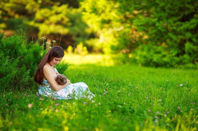 Mom feeds the baby, breastfeeding,summer