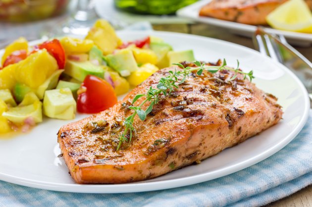 Spice grilled salmon with mango-avocado salsa on a white plate