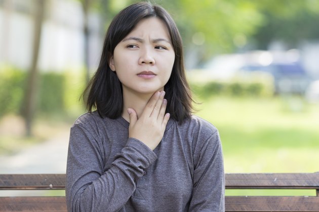 Woman has Sore Throat at Park
