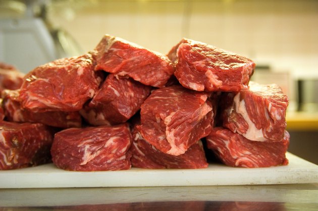 Raw meat on a butcher's cutting board.