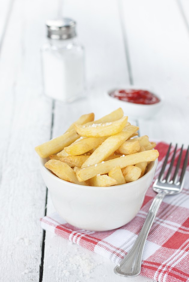 French fries in a white bowl on table