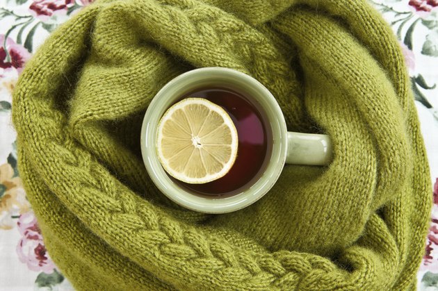 Cup of tea in warm scarf