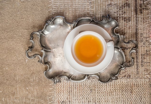 Closeup of cup of tea on vintage textile background