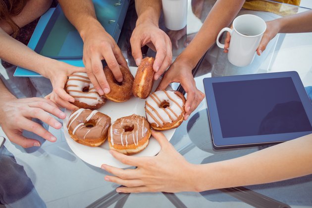 Fashion students eating doughnuts
