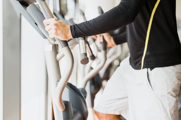 Man working out on a elliptic trainer