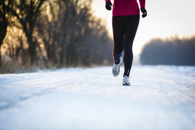 Young woman running outdoors on a cold winter day