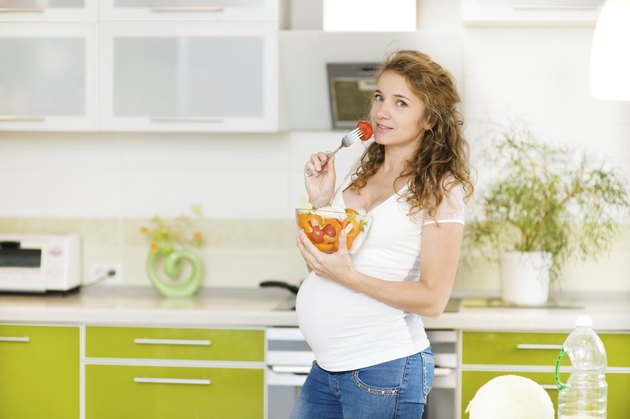 Pregnant woman eating a salad