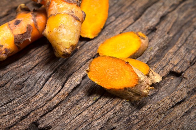 turmeric root on wooden plate