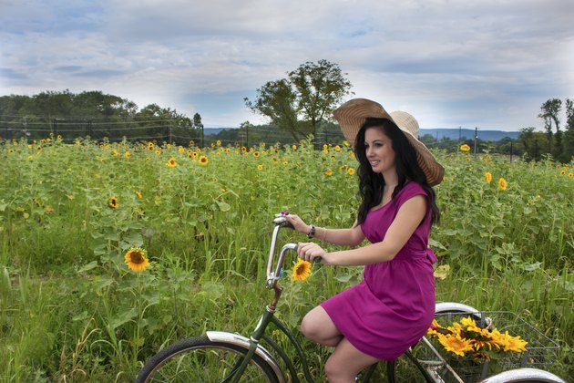 Woman on bike with sunflowers