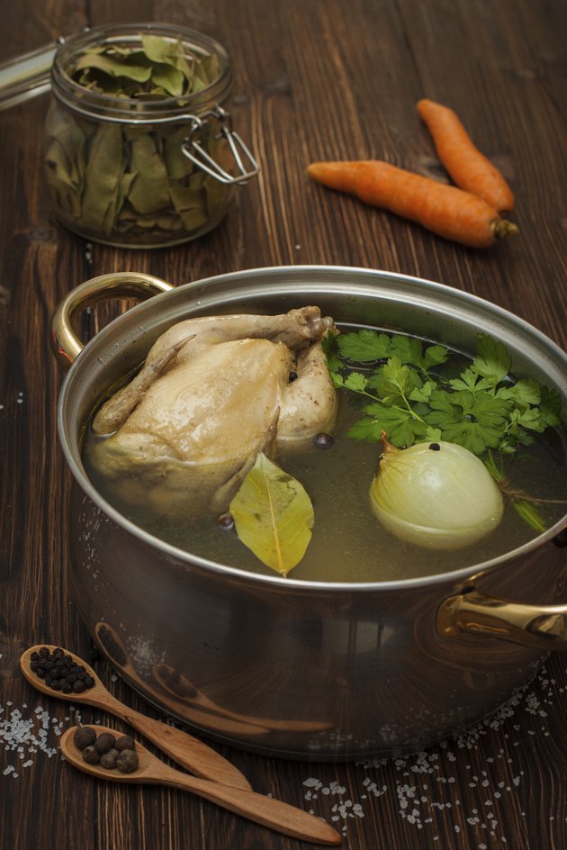 chicken broth with vegetables and spices in a saucepan