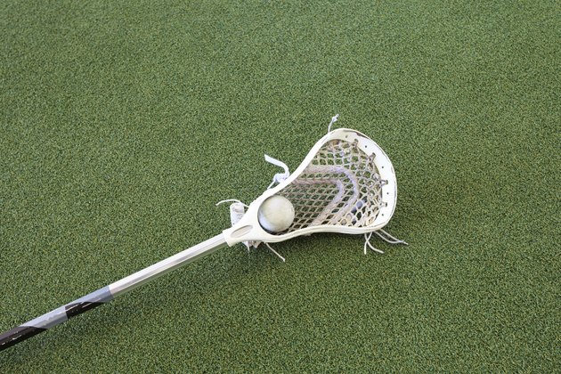 Lacrosse Stick and Ball on Turf