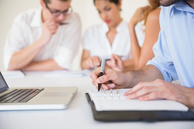 Businessman writing in diary