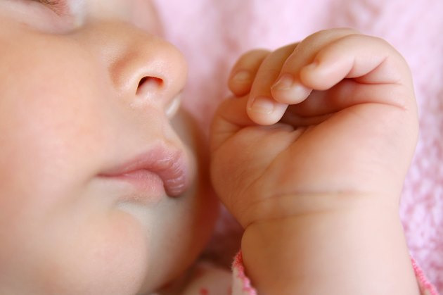 Close up on Hands and Face of Sleeping Baby