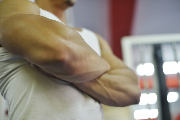 Athletic bodybuilder, execute exercise in sport gym hall
