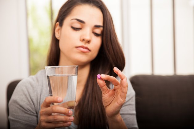 Girl about to take a pill