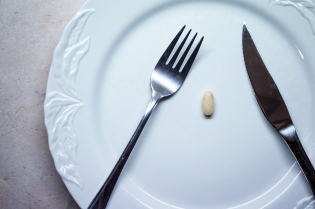 Single Pill/Tablet on a White Dinner Plate Overhead View