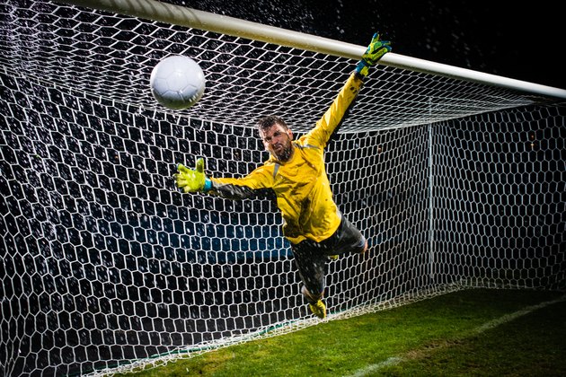 Soccer Goalie Jumping For Ball