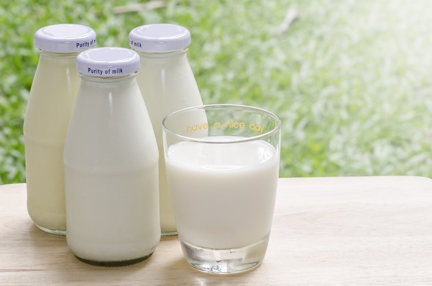 Bottles of fresh milk on table