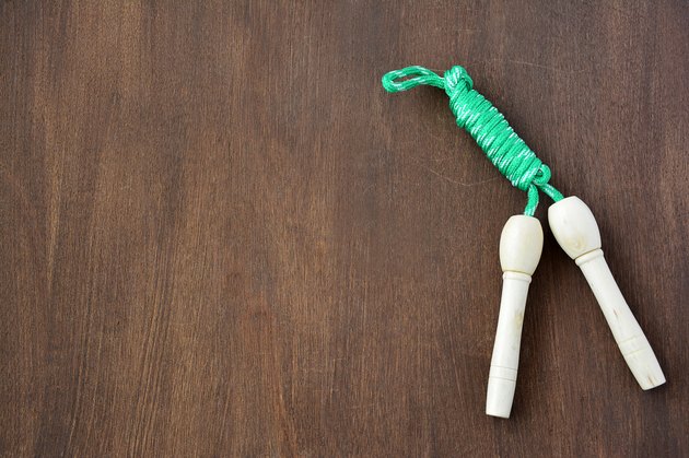 Skipping rope on wooden background.