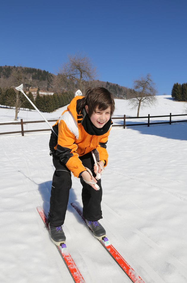young boy goes on cross-country skis on the white snow
