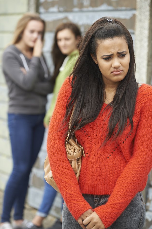 Unhappy Teenage Girl Being Gossiped About By Peers